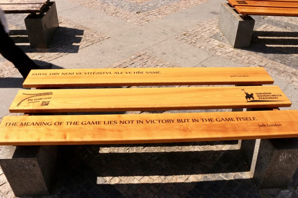 A bench in Prague with the inscription "The meaning of the game lies not in victory but in the game itself."