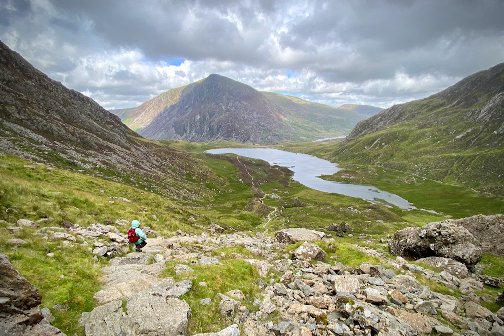 Walking down the boulder field with views towards Llyn Idwal and Pen Yr Ole Wen